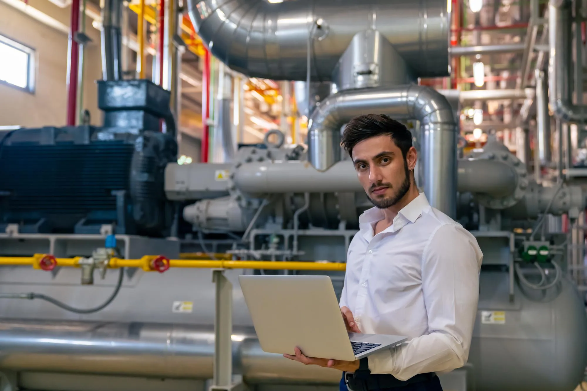professional male electrical engineer working laptop computer factory site control room industrial technician worker maintenance checking power system manufacturing plant room 1411861 1893
